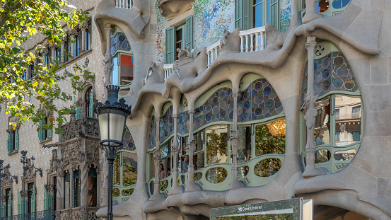 The unusual and surprising 19th / 20th century architecture in Barcelona, Spain Detail of a facade of Casa Batlló by Gaudi. Casa Batlló is one of the two great buildings designed by Antoni Gaudí on Passeig de Gràcia, the other being La Pedrera.\nFrom the outside the façade of Casa Batlló looks like it has been made from skulls and bones. The \