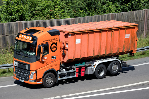 Wiehl, Germany - June 25, 2019: Stubs Volvo FH roll-off conatiner truck on motorway