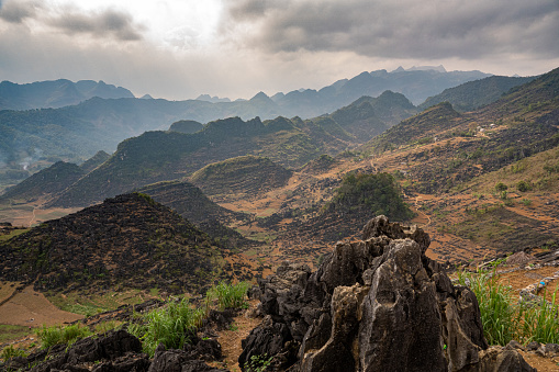 Rocky landscape in the mountain area of North Vietnam (between Yen Mink en Dong Van).dark, threatening clouds and backlight. Karst landscape.