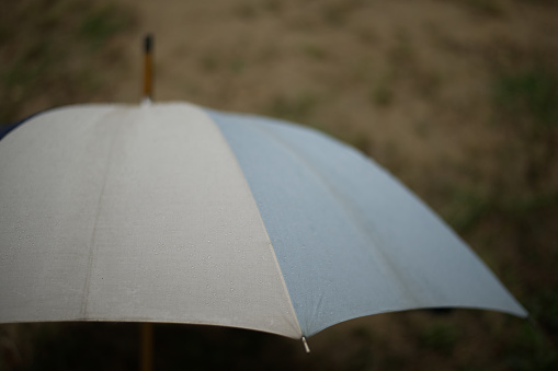 Happy young man holding a umbrella on white background