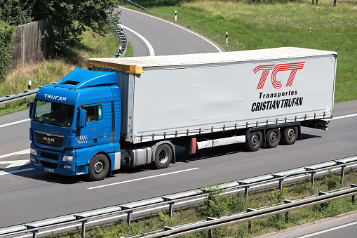 Wiehl, Germany - June 24, 2019: Trufan MAN TGX truck with curtainside trailer on motorway