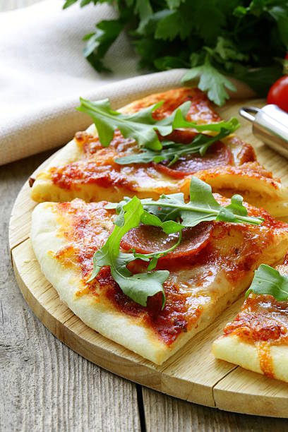 istock Pepperoni pizza with tomato sauce and herbs 178756695
