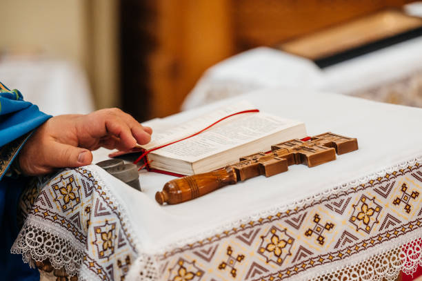 istock The priest's hand is on the Bible, a cross is next to it. 1787575521