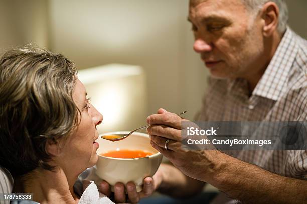 Caring Senior Man Feeding His Sick Wife Stock Photo - Download Image Now - Feeding, Patient, Illness