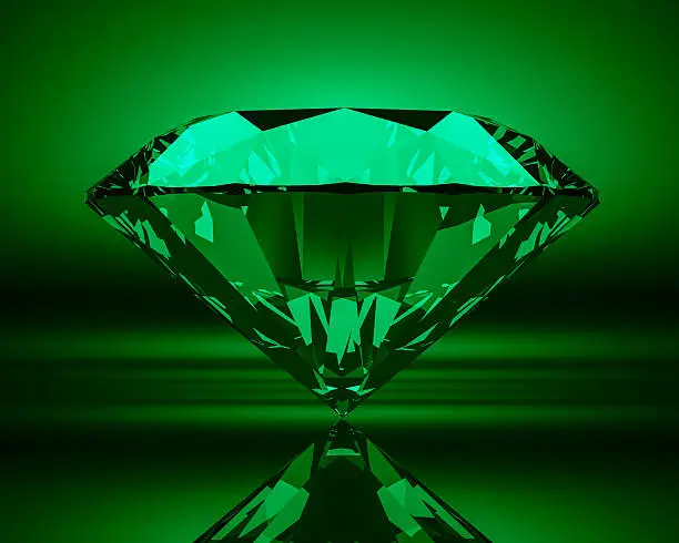 Green emerald on abstract background