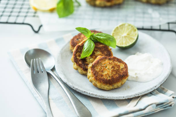 traditional homemade fish cakes with tlemon and sour cream - pollock trawler imagens e fotografias de stock