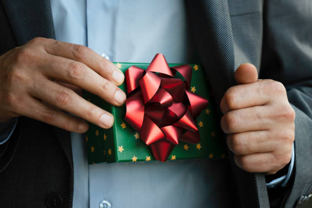 istock Businessman giving Gift Box 1787602603