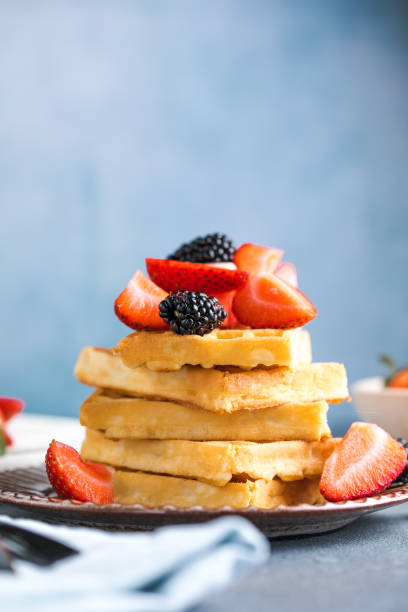 istock Waffles and Strawberries stacked on a plate. Belgian homemade waffles 1787603684