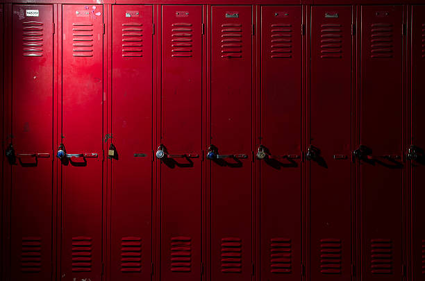 Row of Lockers image of a row of lockers with dramatic lighting locker room stock pictures, royalty-free photos & images