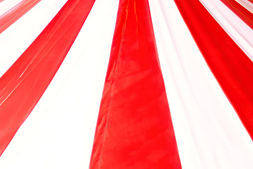 Background of red and white stripes of circus cupola . Vibrant atmosphere stripes dynamic pattern that draws attention and adds a sense of movement