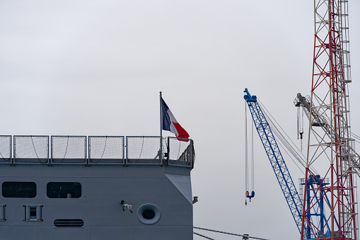 Moored modern supply and tanker warship Jacques Chevallier A-725 at French Navy Naval Base at City of Toulon on a cloudy late spring day. Photo taken June 9th, 2023, Toulon, France.