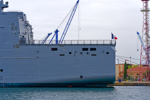 Moored modern supply and tanker warship Jacques Chevallier A-725 at French Navy Naval Base at City of Toulon on a cloudy late spring day. Photo taken June 9th, 2023, Toulon, France.