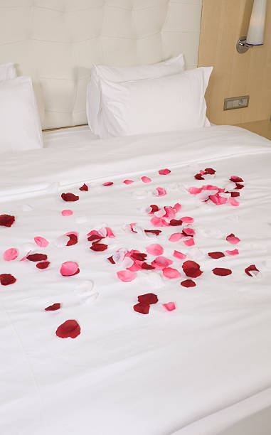 istock hotel room with big bed and red flowers 178761689