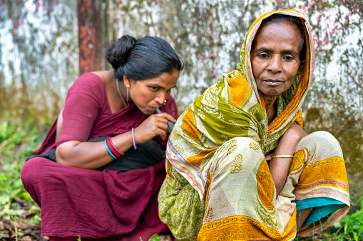 A nomadic gypsy healer from Bangladesh blows through her horn to cure a patient