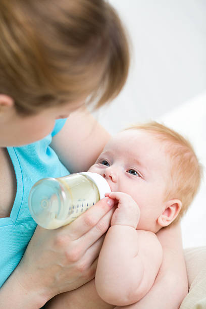 istock mother feeding baby from bottle 178763106