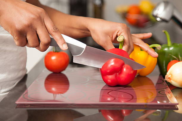 istock African  American womans hand slicing a red pepper 178763603