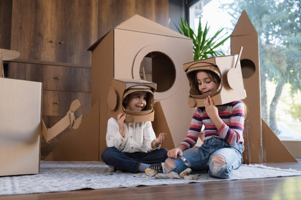 istock Children playing role play game as astronauts on mars. 1787647769