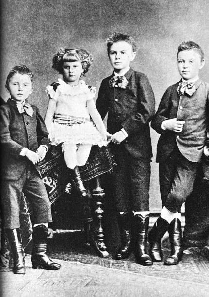 istock Four Siblings studio portrait, three boys, one girl,  1880s 1787648170