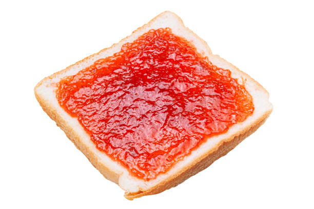 istock Cut Out Spread strawberry jam on a slice of bread 1787648508