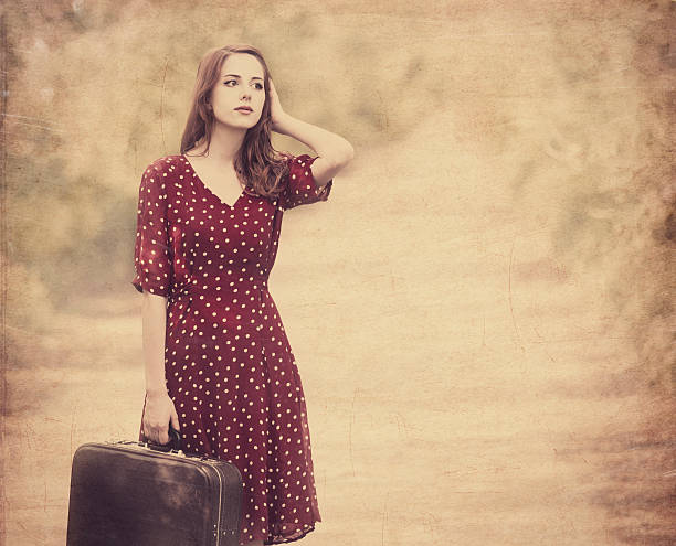 istock Redhead girl with suitcase at tree's alley. 178764965
