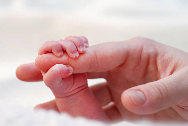 istock Newborn baby holding mom's finger 178765981