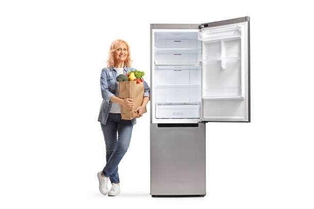 istock Woman with a grocery bag leaning on an open fridge 1787662623