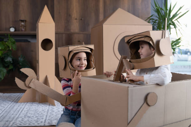 istock Children playing role play game as astronauts on mars. 1787667620