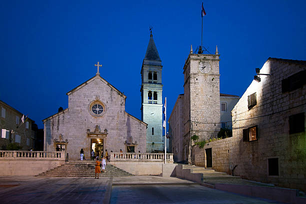 Supetar by night Night view of Parish Church of the Blessed Virgin Mary in Supetar on Brac island, Croatia old catholic church on island brac croatia stock pictures, royalty-free photos & images