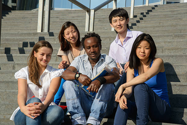 istock Multiethnic group of young people sitting on steps 178767446