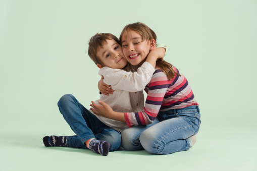 Portrait Of Brother And Sister Hugging