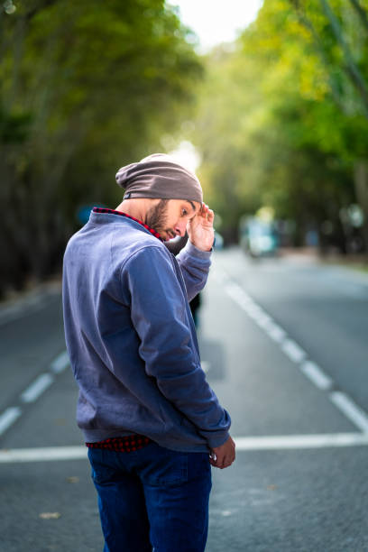 city cowboy vibes: denim, hat, autumn sunlight. - autumn street single lane road tree imagens e fotografias de stock