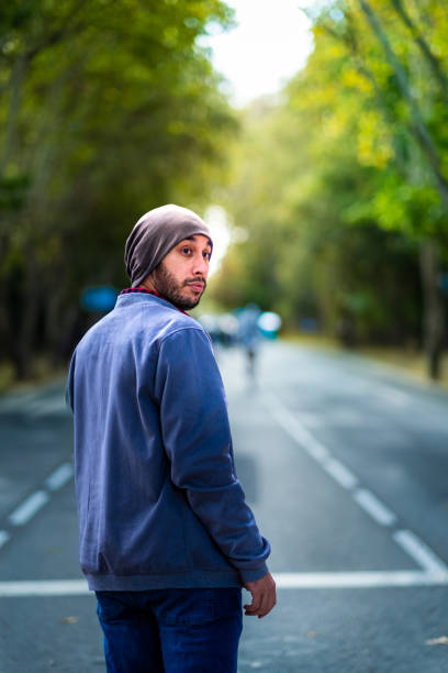 casual madrid charm: bearded gent, street style. - autumn street single lane road tree imagens e fotografias de stock