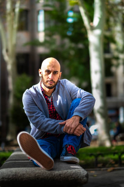 istock Casual elegance: Caucasian man, red-check shirt, jacket, bald, kicks back in Madrid. 1787684530