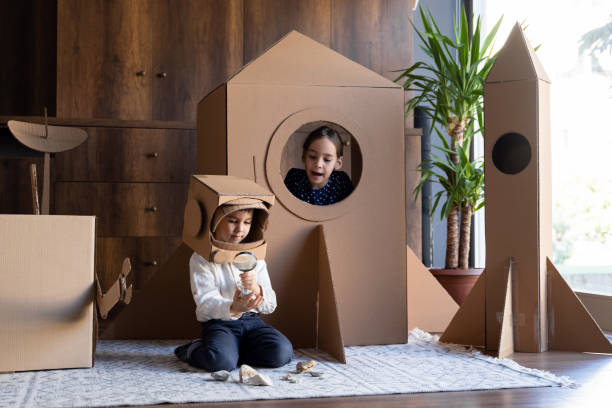 istock Children playing role play game as astronauts on mars. 1787685678