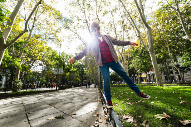 istock Autumn equilibrium: Bearded guy, wide-angle shot, effortlessly balances on Madrid's street. 1787685960