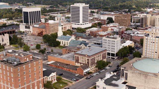Macon City Auditorium and First Presbyterian Church are main noticeable landmarks of Mulberry Street in Macon, Georgia. Aerial footage with panning camera motion