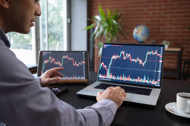istock Man Checking His Stock Market Exchange Investment Using His Laptop Computer. 1787688255