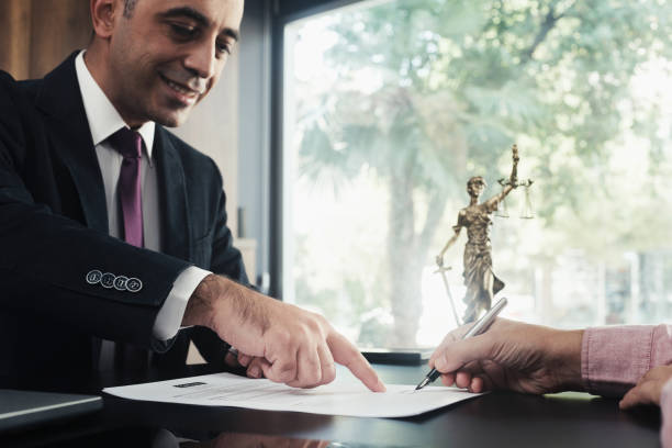 istock Lawyer and the client signing legal agreement documents 1787690144