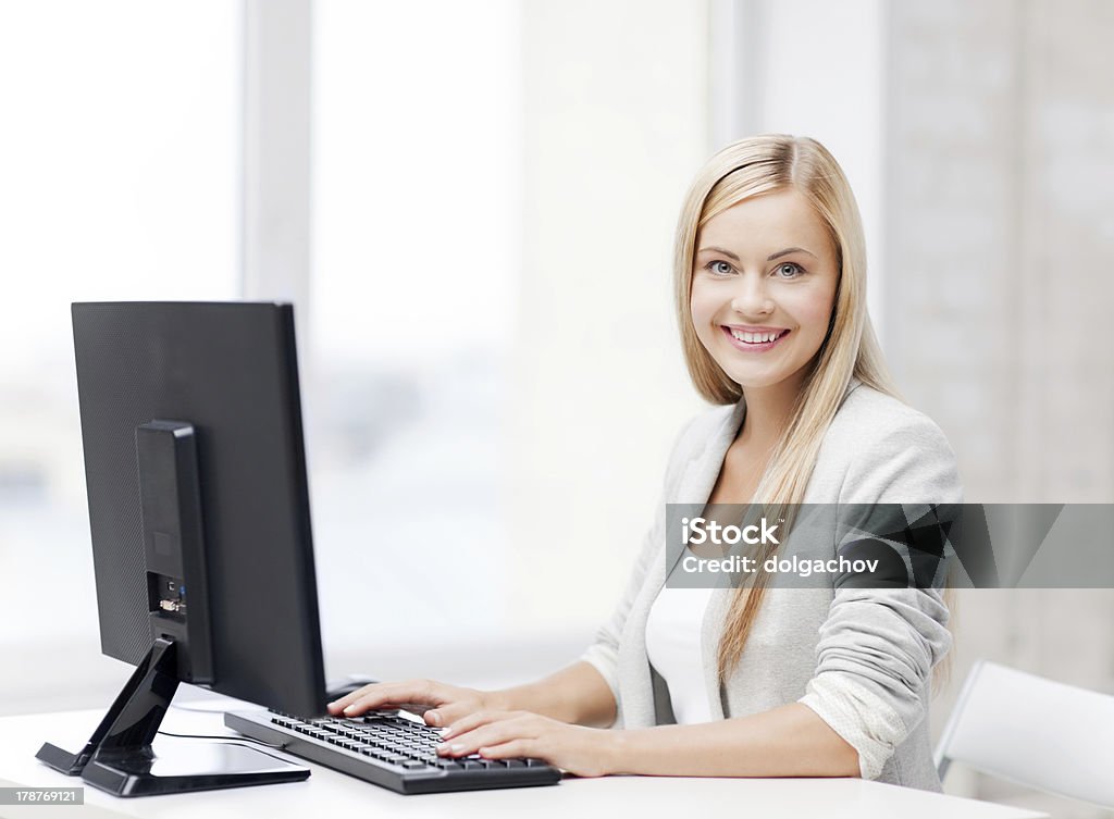 businesswoman with computer picture of smiling businesswoman using her computer Human Face Stock Photo