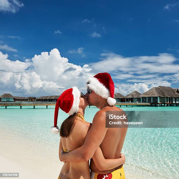 Couple In Santas Hat On A Beach At Maldives Stock Photo - Download Image Now - Adult, Adults Only, Beach