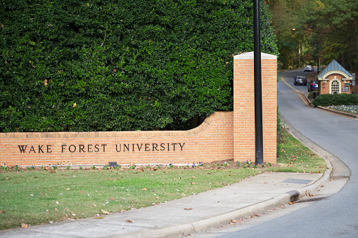Winston-Salem, North Carolina - October 27, 2023: Wake Forest University sign on brick wall near Reynolda Road in Winston-Salem, North Carolina