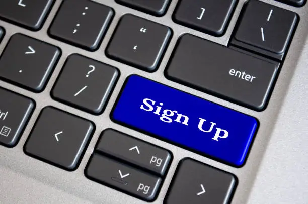 Photo of Sign up text on blue keyboard. Sign up and online registration concept.