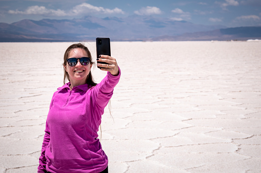 Tourist posing in Salinas Grandes, Jujuy, Argentina. Tourist taking a photo in Salinas Grandes, Argentina. Happy person in the great Argentine salt flat.