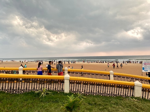 Calangute, Goa, India - October 14 2023: Tourists enjoying a view of the beach from a viewpoint at the popular Calangute beach in Goa.