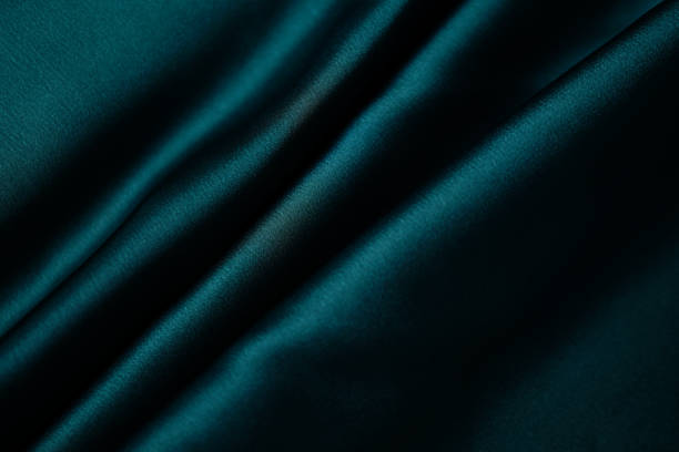 istock Emerald green silk or satin, draped fabric, elegant background. 1787694953