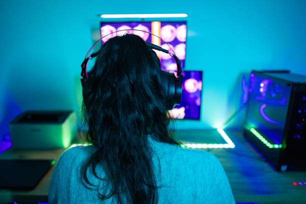 istock Happy young woman playing a video game 1787696414