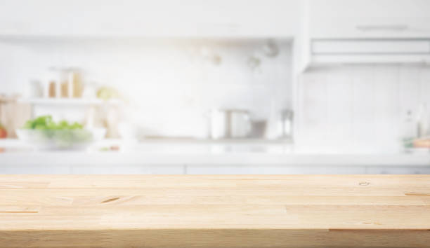 istock Selective focus.Wood table top on blur kitchen counter in morning background.For montage product display or design key visual layout. 1787698698