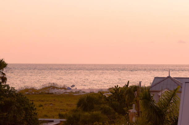Breathtaking view of coast from balcony in Anna Maria Island; sand dunes and hazy water at tranquil night