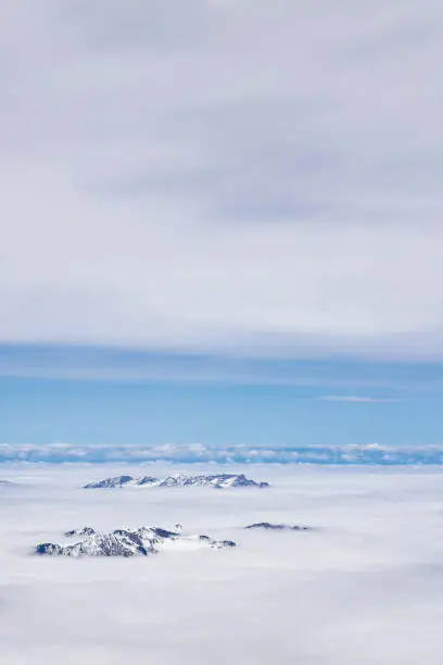 Mountain tops between clouds view from top of Mount Titlis at 3020 meters altitude in Engelberg Switzerland