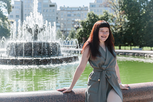 Portrait of a young adult woman in city Park